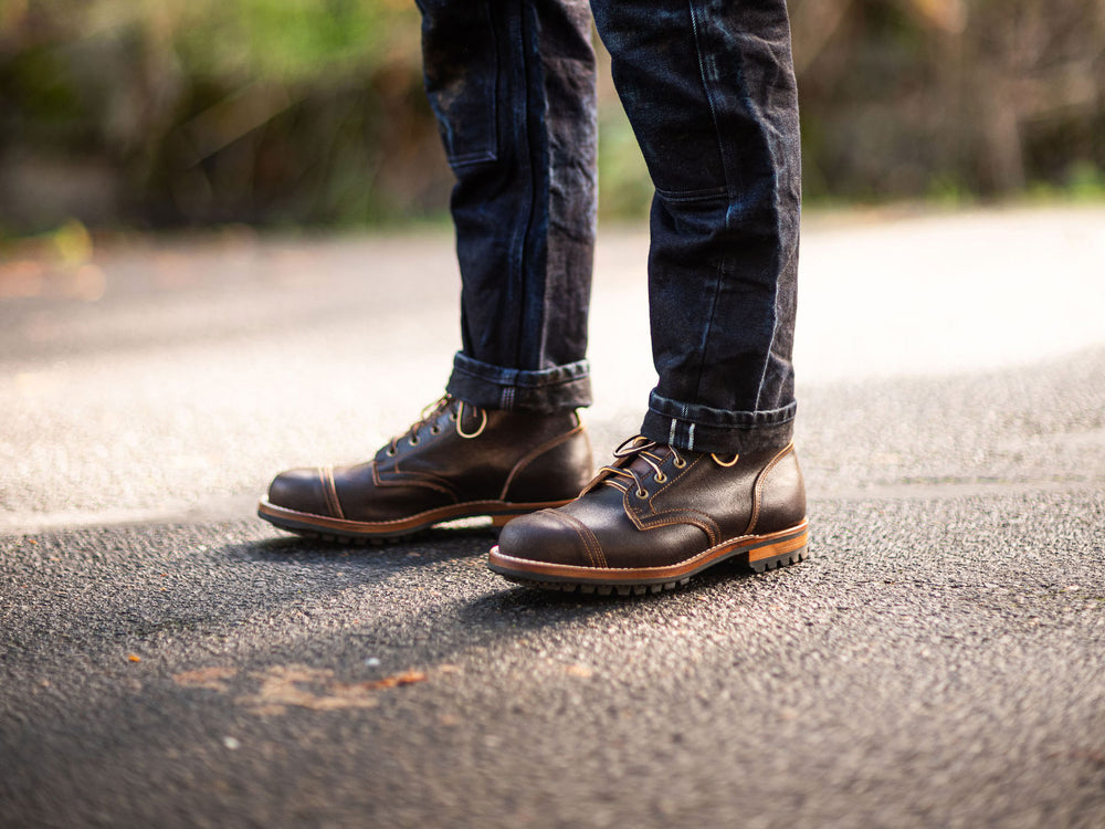 man wearing selvage denim with Truman java waxed flesh boots