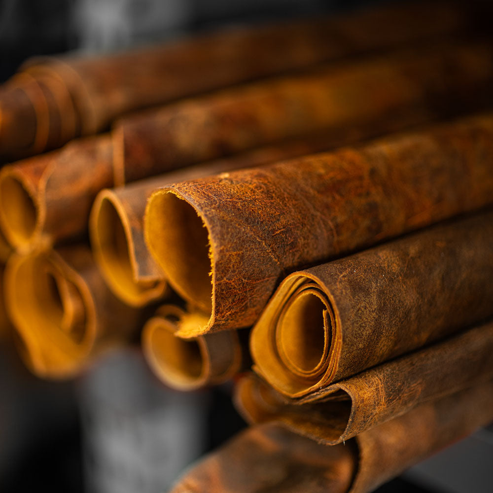 rolls of coach rambler leather on storage rack