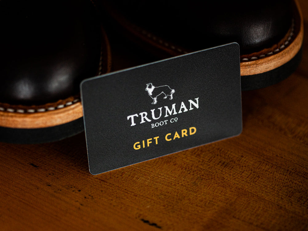 Physical gift card next to pair of boots